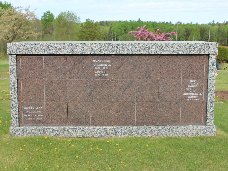 Image of granite columbarium lighter grey/black with red/grey fronts.